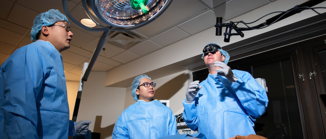 Researchers discuss smart goggles in a medical laboratory