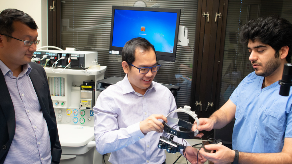 Researchers work with smart goggles in a lab
